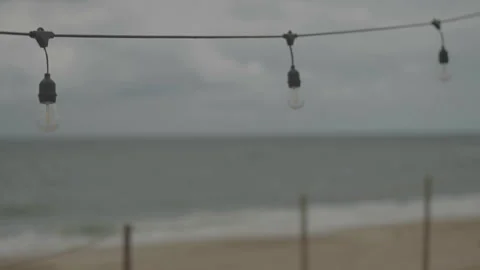 Beach with string lights and rack focus Video stock 346282116