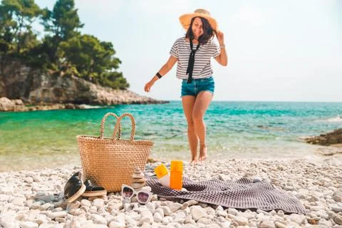 Beach stuff straw hat and bag with flippers and sun protection cream Stock Photos