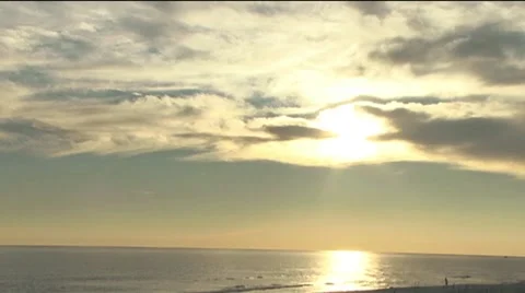 Beach with sun reflecting thru clouds Stock Footage 41287963