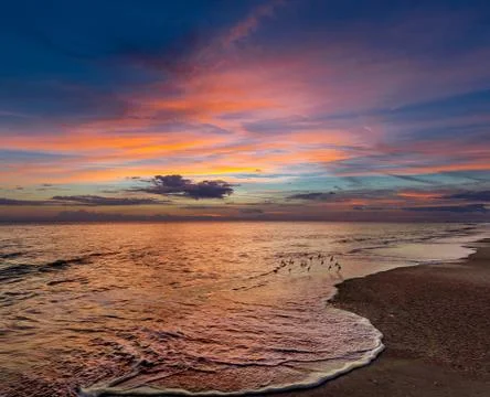 Beach at sunrise Stock Photos