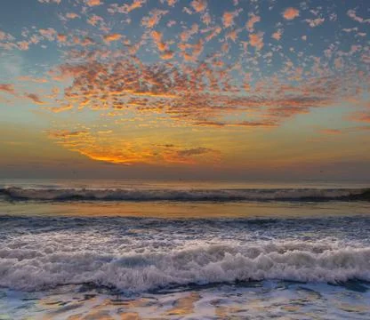 Beach at sunrise Stock Photos