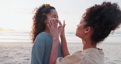 Beach, sunscreen and application by mother and daughter at the ocean for summer Video stock 257521469