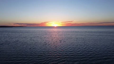 Beach Sunset aerials moving low over the rippling water 4K Stock Footage 152493955