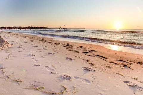 A beach with a sunset in the background Foto stock