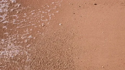 Beach at sunset. close-up of slow motion waves on the beach Stock Footage 167627000