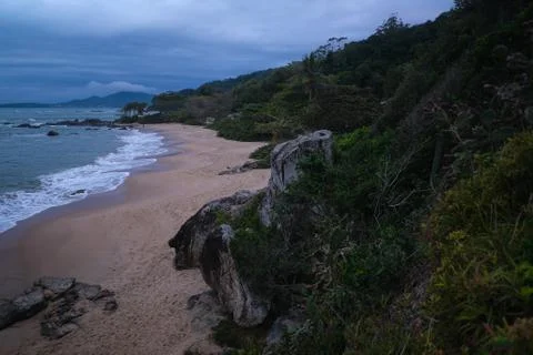 The beach at sunset clouds mountains Stock Photos