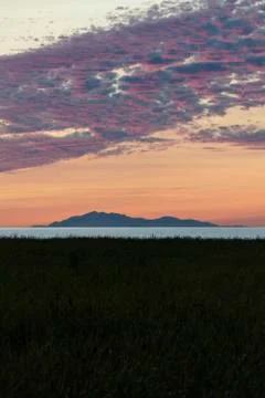 Beach sunset with crimson clouds Stock Photos