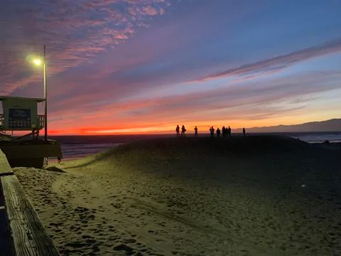 Beach sunset with distant mountain views Stock Photos