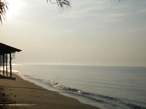 Beach with sunset light at evening. Stock Photos