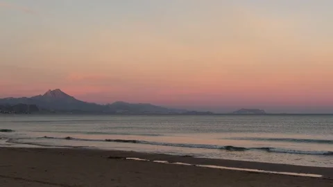 Beach at sunset with mountain in the distance, San Juan, Alicante, Spain Stock Footage 294387091