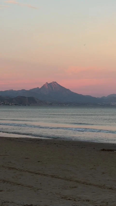 Beach at sunset with mountain in the distance, San Juan, Alicante, Spain Stock Footage 294387096