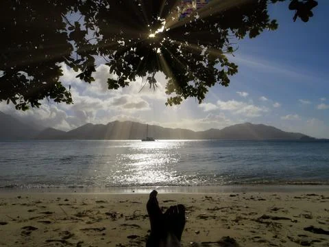 Beach at sunset, mountains in the background Stock Photos