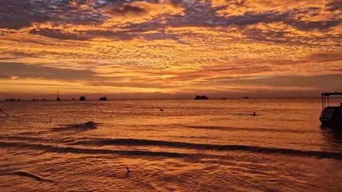 Beach Sunset with Orange Clouds and Playful Ocean Frolic 2 Stock Footage 240877962