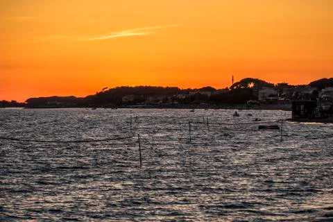 Beach at sunset with orange sky Foto stock