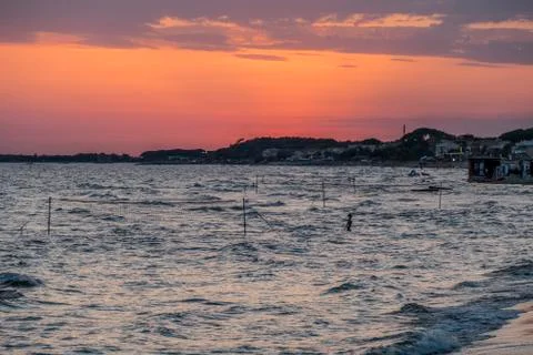 Beach at sunset with orange sky Stock Photos