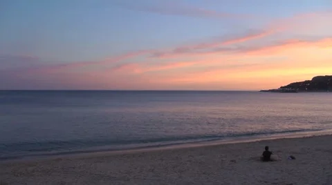 Beach at sunset with a person contemplating Stock Footage 8665643