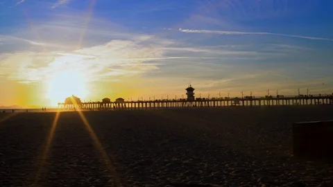 Beach sunset with pier in background, 4K Stock Footage 101002279