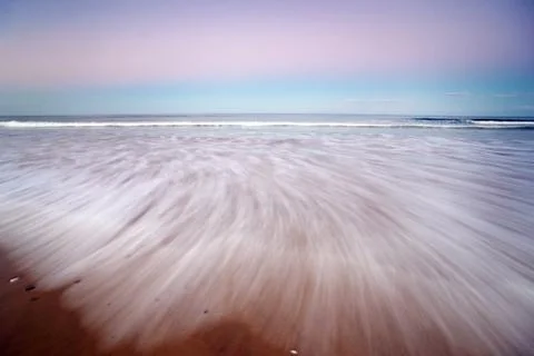Beach sunset scene Stock Photos