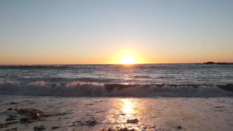Beach sunset, slow motion dolly right. Low angle. Stock Footage 161246360
