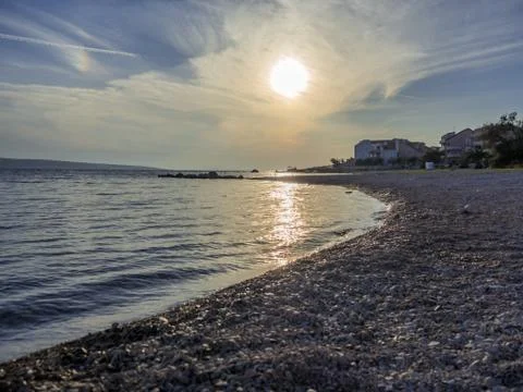 Beach sunset with small waves and beautiful sand at evening. Stock-Fotos