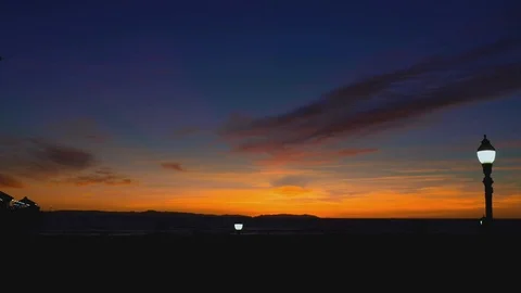Beach at sunset with some lights, 4K Stock Footage 101002444