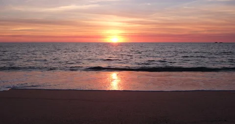 Beach sunset with sun reflected on the wet sand Stock Footage 139534181