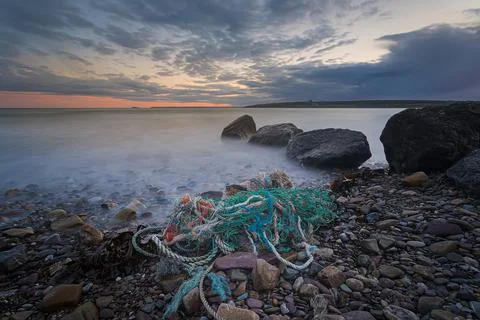 : Beach at sunset time, with stunning clouds formation with nautical fishing  Foto stock