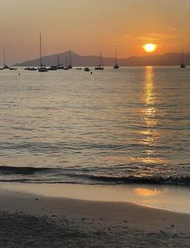 Beach at sunset time in summer on beach. Nature and mountains. Vacation in Stock Photos