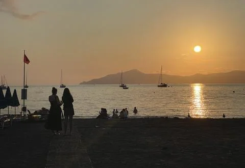 Beach at sunset time in summer on beach. Nature and mountains. Vacation in Stock Photos