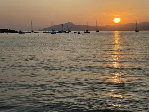 Beach at sunset time in summer on beach. Nature and mountains. Vacation in Stock Photos
