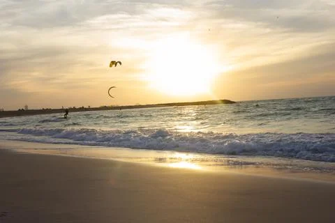 Beach at sunset under the sky Stock Photos