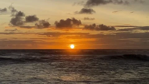 The beach at sunset with waves and beautiful colored skies Stock Footage 297053477