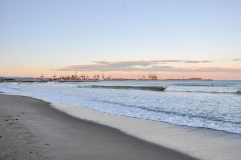 Beach at sunset with waves Stock Photos