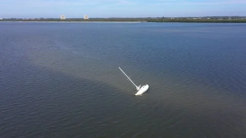 Beach sweep zoom broken down sailboat Fort Myers Stock Footage 156403708