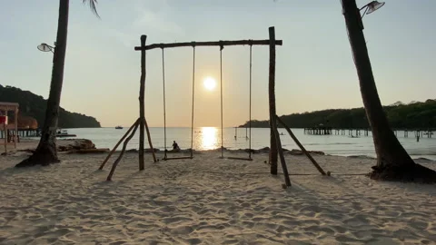Beach swing and watching ocean waves. Stock Footage 197057314