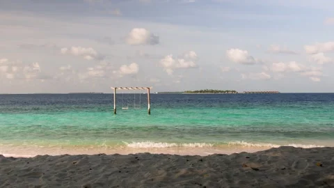 Beach swing and watching ocean waves. Carefree summer moment at ocean beach Stock-Footage 249802066