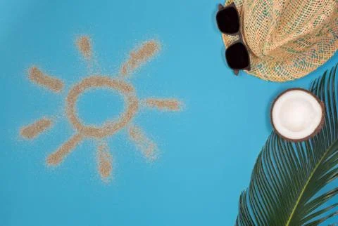 Beach theme on blue background. Sun drawn by the sand on blue background. Top Stock Photos