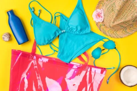 Beach theme on the yellow background. Beach bag and summer accessories, on th Stock Photos