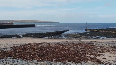 Beach at Thurso at Low Tide with Seaweed Rocks and Waves on a Dull Spring Day Stock Footage 332069883