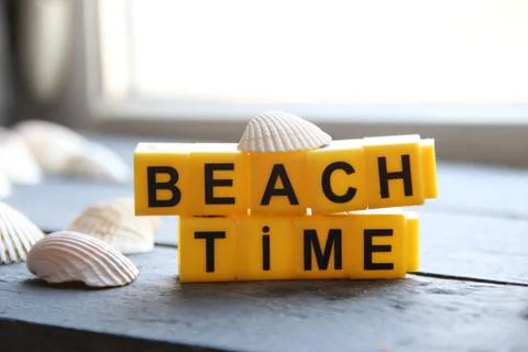 Beach time creative concept yellow lettering lettering Stock Photos