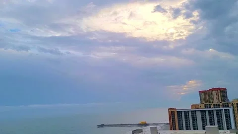 Beach time-lapse Atlantic ocean of clouds over the beach with peaks of sun pier. Stock Footage 170572486
