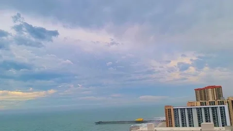 Beach time-lapse Atlantic ocean of clouds over the beach with peaks of sun pier. Stock Footage 170574240