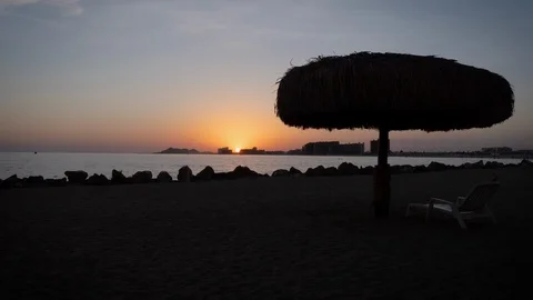 Beach Timelapse of Sunset in Mexico with Palm Umbrella and Lounge Chair - 4K Stock Footage 94967325
