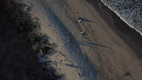 Beach top view solo surfer entering water, waves on shore Stock Footage 97175042