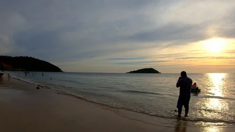 The beach with tourists at sunset. Video stock 100631959