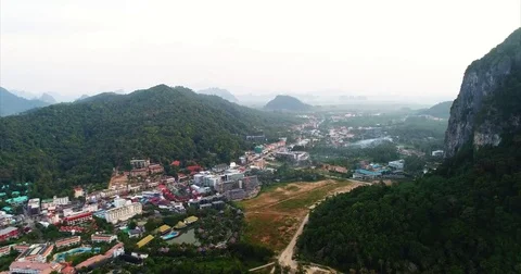 Beach town spread across a valley floor among karst towers 스톡 동영상 71297344