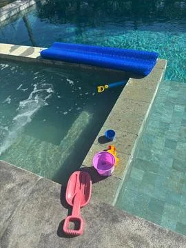 Beach Toys by the Pool Stock Photos