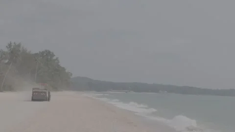 A beach tractor is operating along the coastline. Video stock 344093884