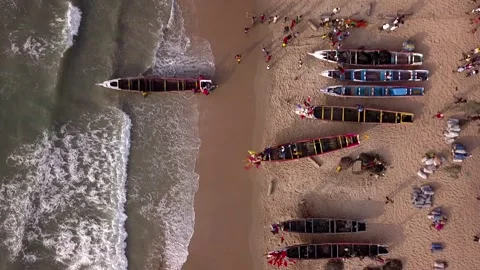 Beach with trees, people walking and traditional fishing boats Stock Footage 208936693