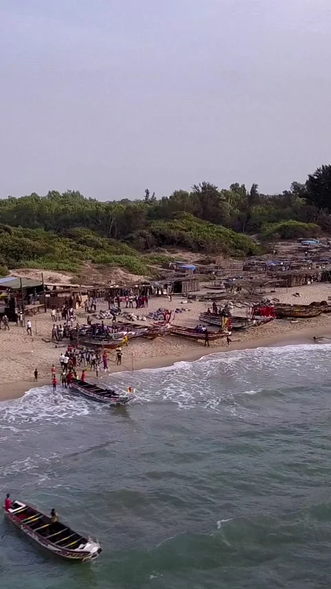 Beach with trees, people walking and traditional fishing boats 스톡 동영상 230668261